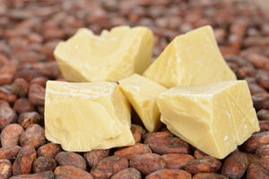 100% raw unrefined cocoa butter in glass jar, organic skincare and food grade
